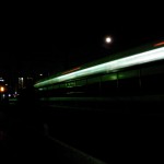 A full moon hangs over a passing train